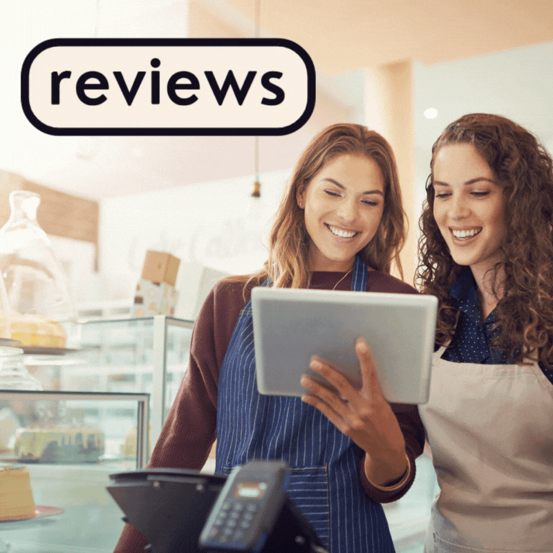 A small business owner reading positive reviews from customers.